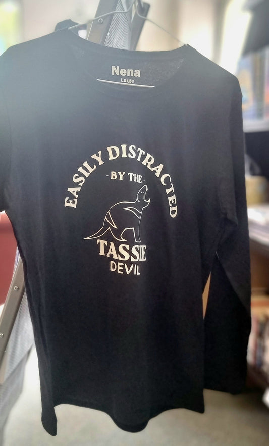 Black t-shirt with white text and graphic on a hanger