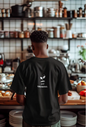 Person wearing a black t-shirt with 'Still Growing' text in a kitchen setting
